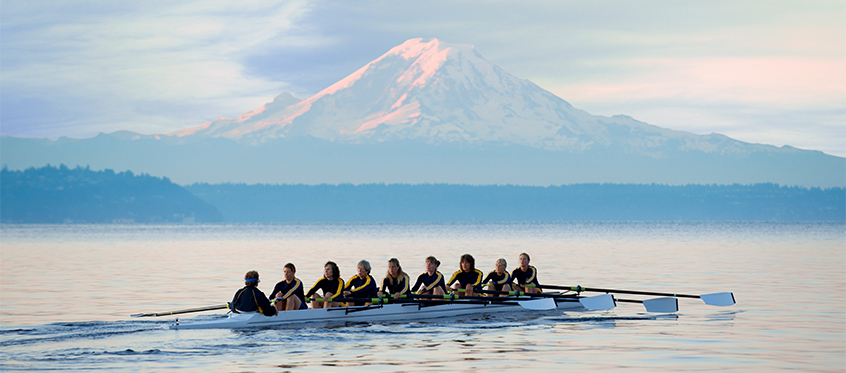 Rowing Team on Lake with Mountain Background