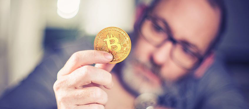 Man Holding Bitcoin for Defensics SDK Fuzzing