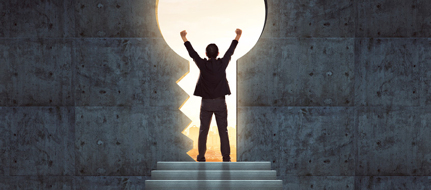 Man Standing Victorious in Keyhole Opening