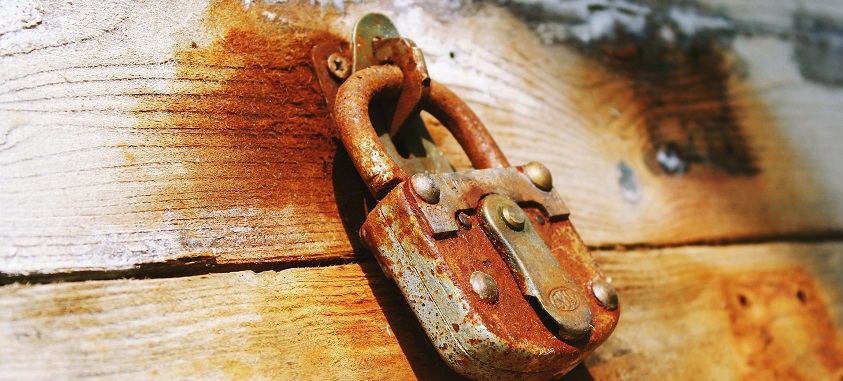 Rusty Padlock On Wooden Door
