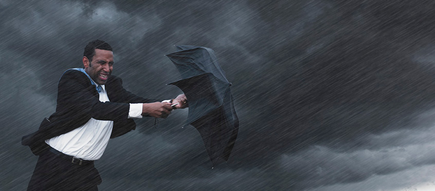 Man Battling Storm with Umbrella
