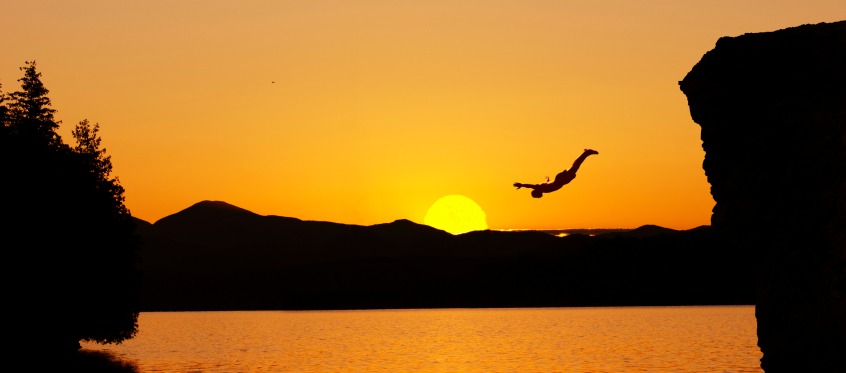 Sunset Cliff Diver Over Lake