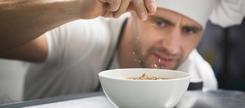Chef Adding Spice to Dish